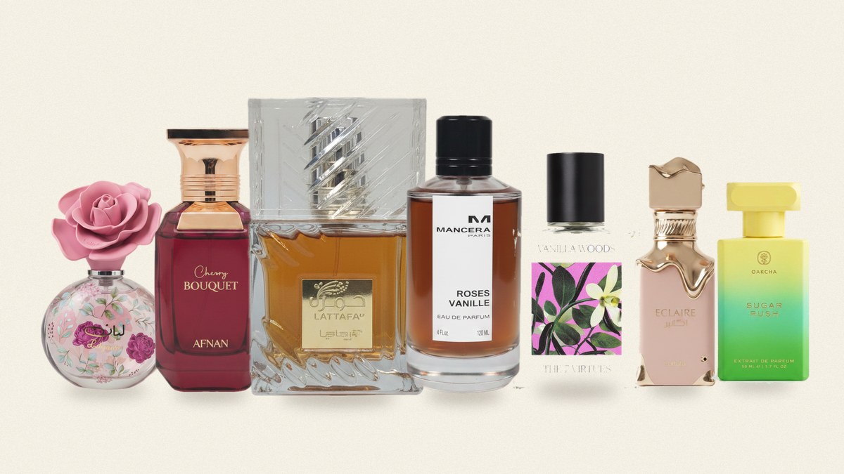 Seven perfume bottles arranged side by side on a parchment background